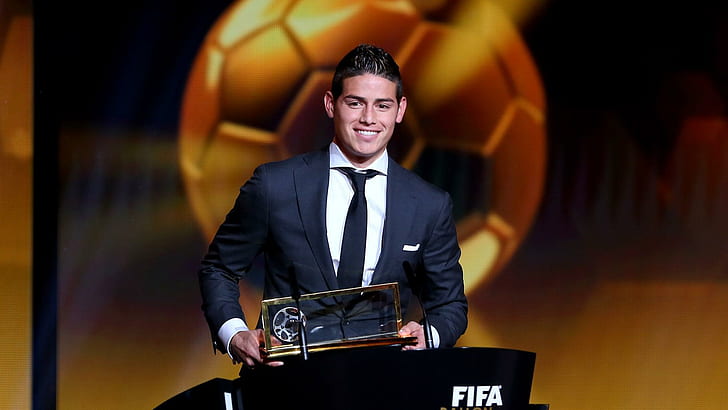 FIFA Puskas Award winner James Rodriguez of Colombia and Real Madrid accepts his award, men's blue dress suit