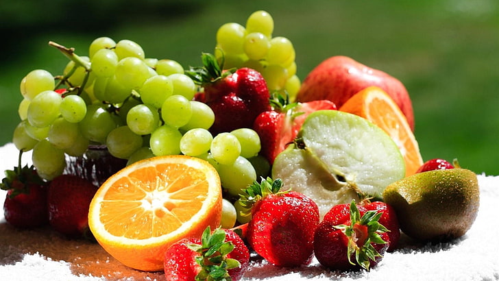 assorted sliced fruits, grapes, apple, orange, kiwi, strawberry