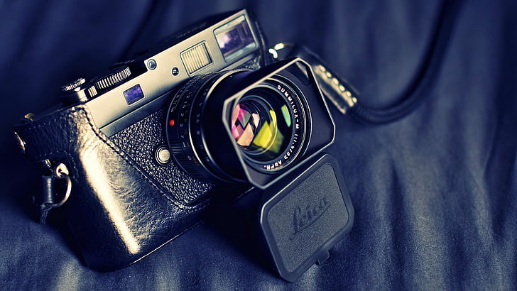 black rangefinder camera, photography of black and silver SLR camera