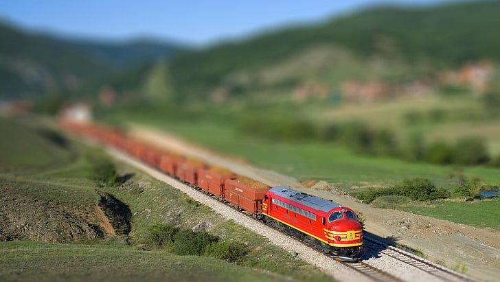 red and yellow train, red steam train toy in macro shot, blurred