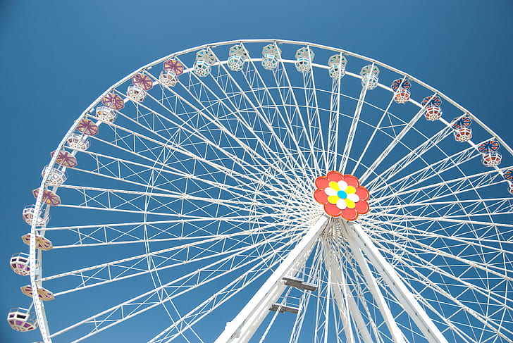 low angle photo of white ferris wheel under blue sky during daytime