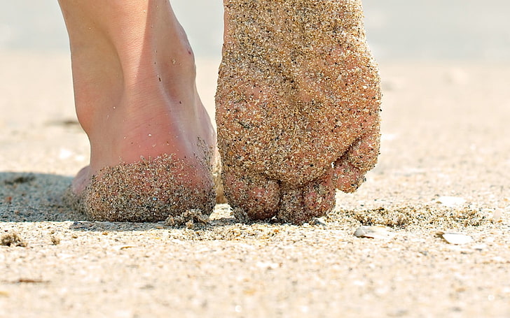 human feet, sand, barefoot, worm's eye view, closeup, sand covered