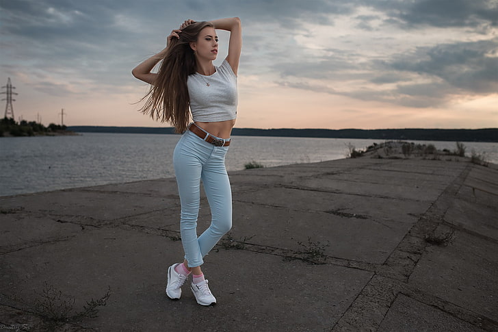 women's white crop top and teal pants, arms up, Dmitry Shulgin
