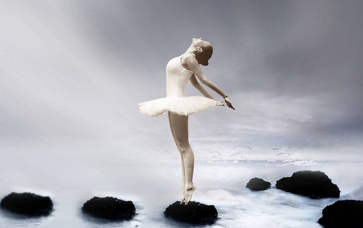 Ballerina sitting on the floor in a studio or on a stage, in a pose during