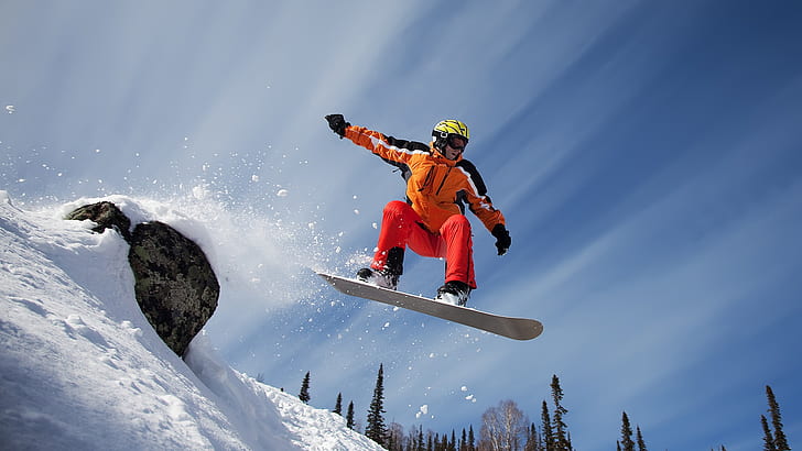 Snow mountain snowboard sport, men's orange snowboarding outfit with white wooden snowboard