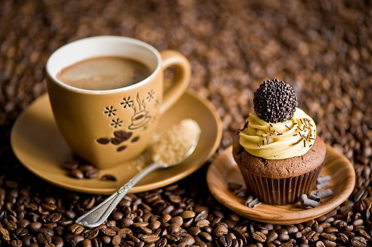 cupcake and brown ceramic coffee cup, coffee beans, photography