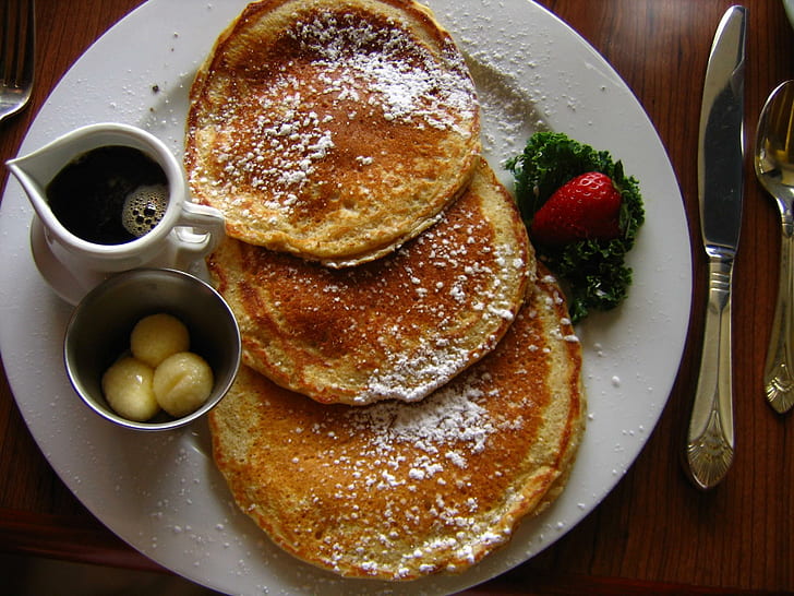 Food Pancakes, three pancakes with strawberry fruit in white ceramic plate
