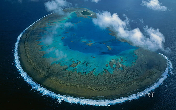 aerial photography of island, sky, sea, water, coral, aerial view