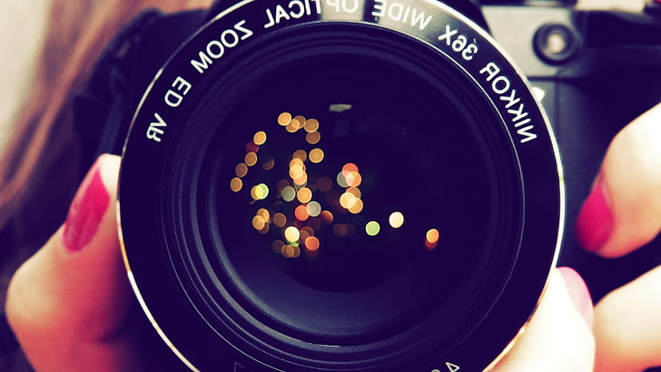 black Nikkor zoom lens, closeup photo of camera, women, macro