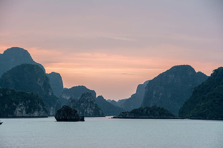 landscape photography of rocky island and ocean under cloudy sky, ha long bay, vietnam, ha long bay, vietnam