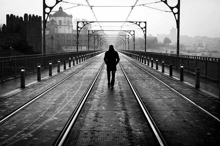 human walking in the middle of railway, laurent, street photography