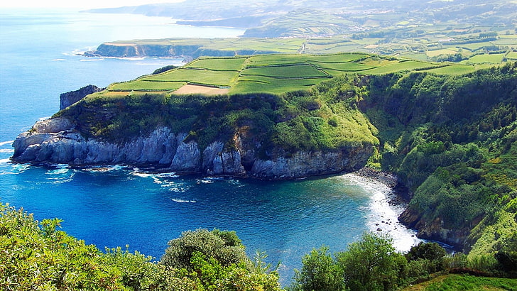 landscape view of greenfield beside the body of water, sea, cliff