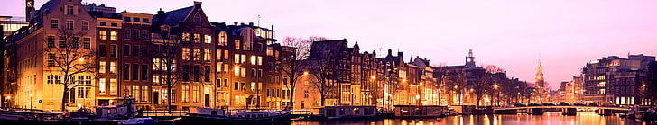 panoramic photo of brown buildings, canal, street, city, lights