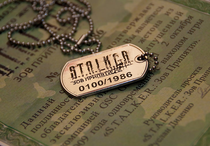 silver-colored Stalker pendant, badge, call of pripyat, close-up