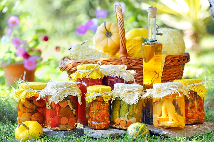 several glass jars, flowers, basket, oil, pumpkin, tomatoes, bottle