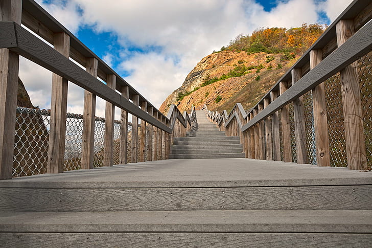 brown wooden bridge through mountain during daytime, sideling hill, sideling hill