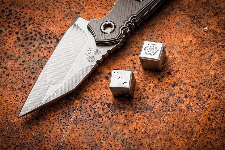 brown folding knife, dice, indoors, still life, no people, table