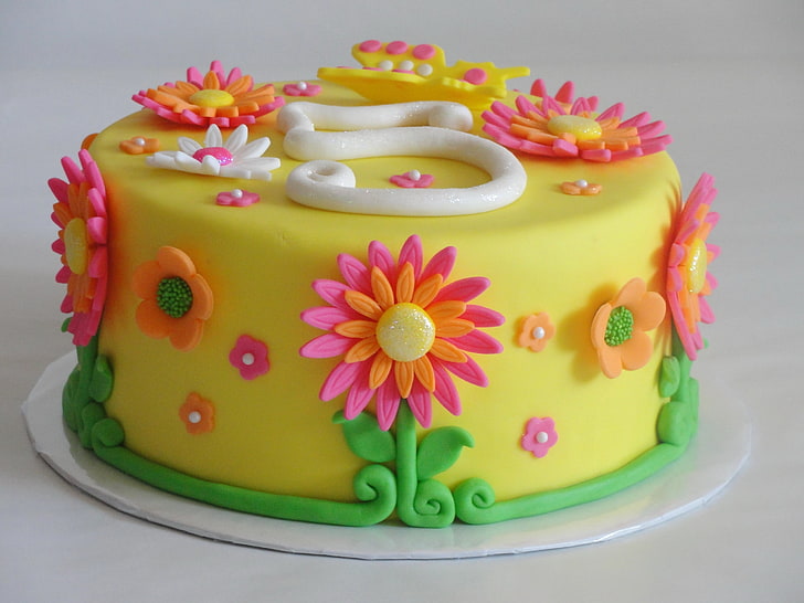 yellow, pink, and green floral fondant cake, frosting, cream