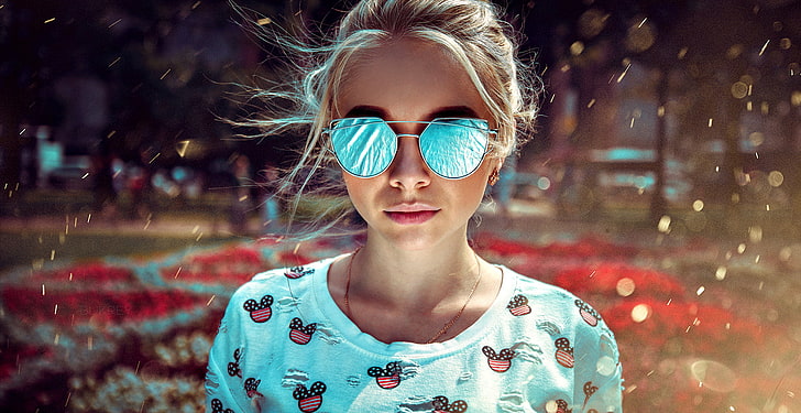 women's blue lens sunglasses with silver-colored frames, woman wears sunglasses and teal crew-neck shirt