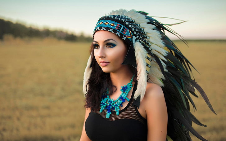 white native American headdress, dark hair, black clothing, blue