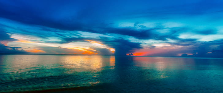 blue skies and clouds with body of water photography during sunset