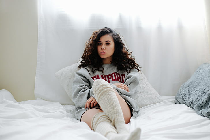legs crossed, sweater, in bed, curly hair, knee-highs, face