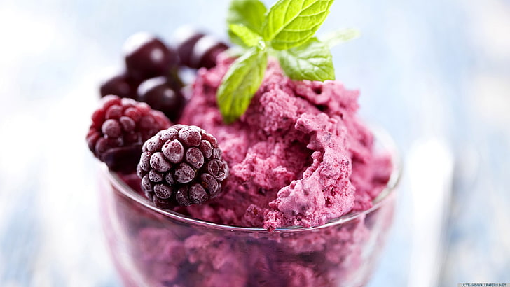 pink ice cream with fruit toppings and mint leaf, shallow focus photography of raspberry ice cream