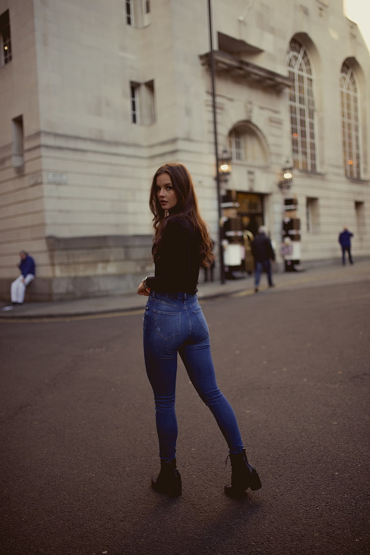 women's black long-sleeved shirt and blue denim fitted jeans