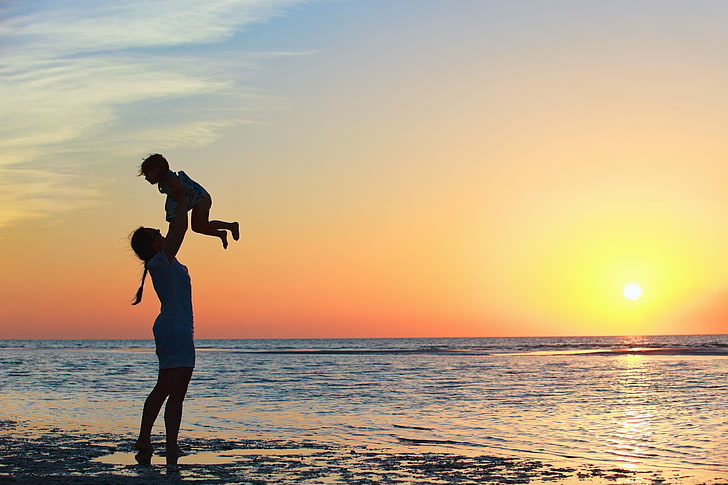 silhouette of woman and child, sea, wave, girl, the sun, joy