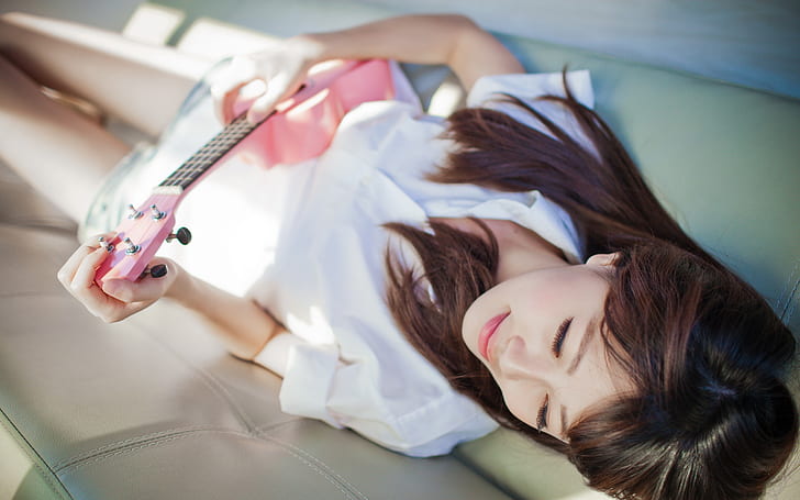 Girl lying bed, guitar, music