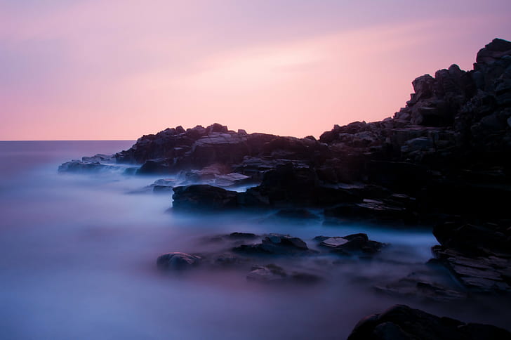 black rock formation covered with fog, seascape, sunset, long exposure
