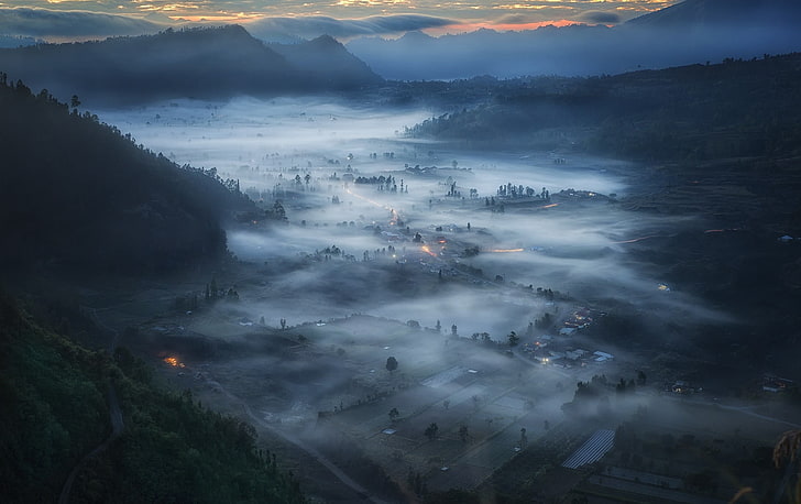 village surround by mountains illustration, aerial photography of fog covered town