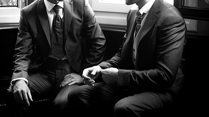grayscale photo of two person wearing blazersq, men, suits, sitting