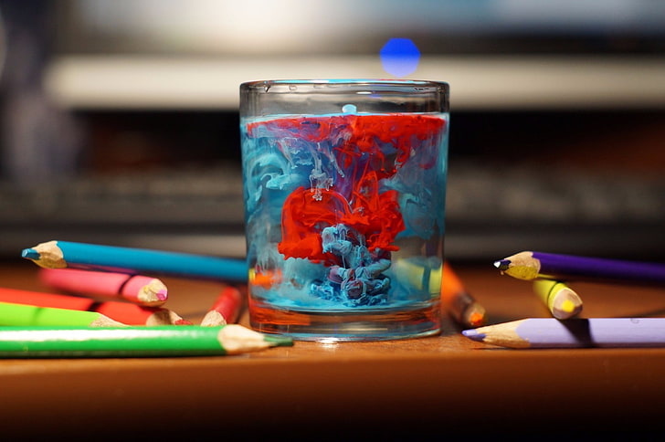 table, glass, water, pencils, paint splatter, colorful, depth of field