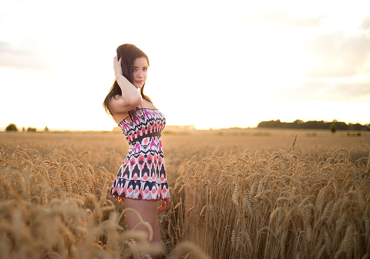 woman wearing white, pink, and black tribal print tube dress on wheat field