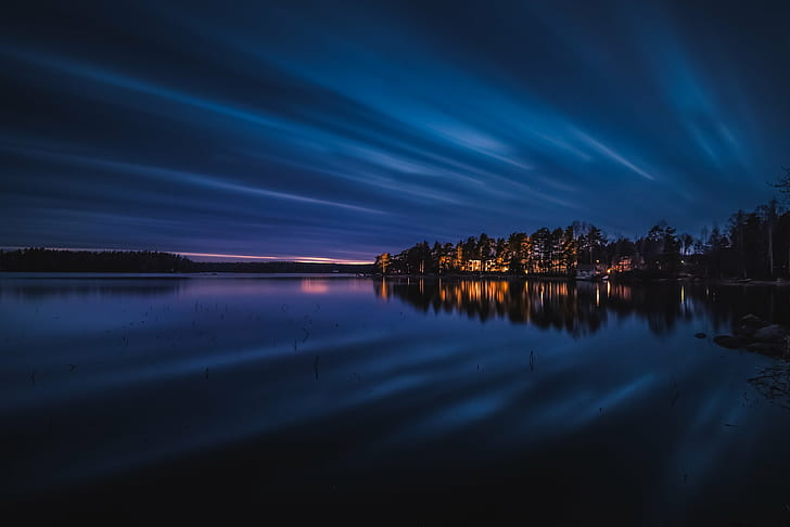 landscape photography of body of water beside lighted town, Cloudy