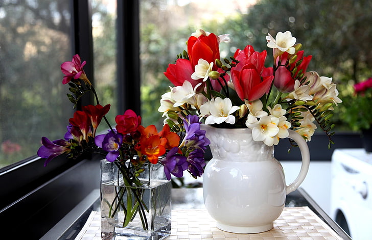 two purple, red, and white freesia and tulips centerpieceds, flowers