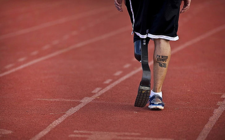 men's black artificial running legs, tattoo, prosthesis, one person