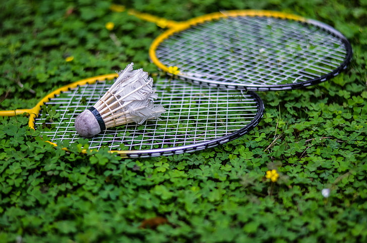 two yellow badminton rackets, shuttlecock, tennis, selective focus