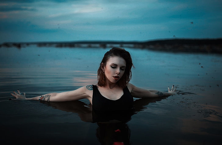 women's black sleeveless top, river, closed eyes, tattoo, wet body