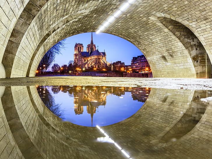 France, Paris, Notre Dame Cathedral, under the bridge, water reflection, brown tunnel