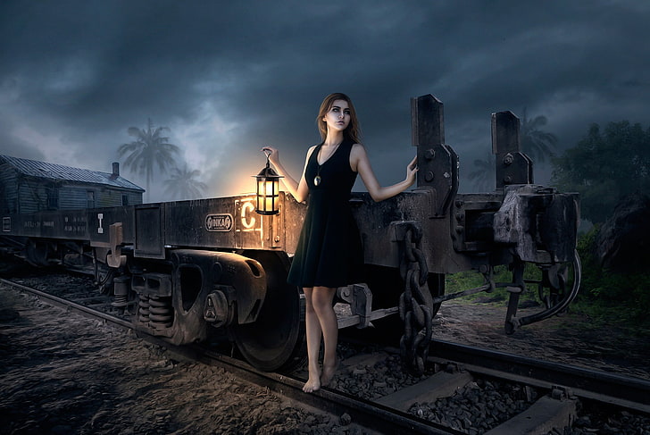 painting of woman wearing black sleeveless mini dress holding lantern near black train on rail