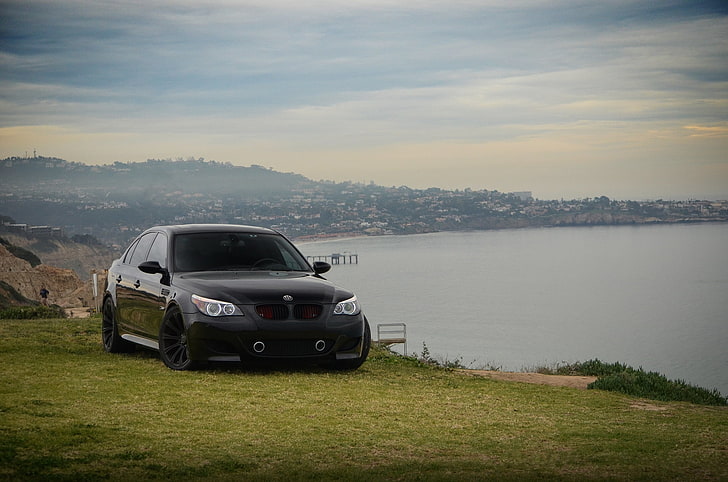 black BMW E60 sedan, sea, the sky, clouds, tuning, slope, front view