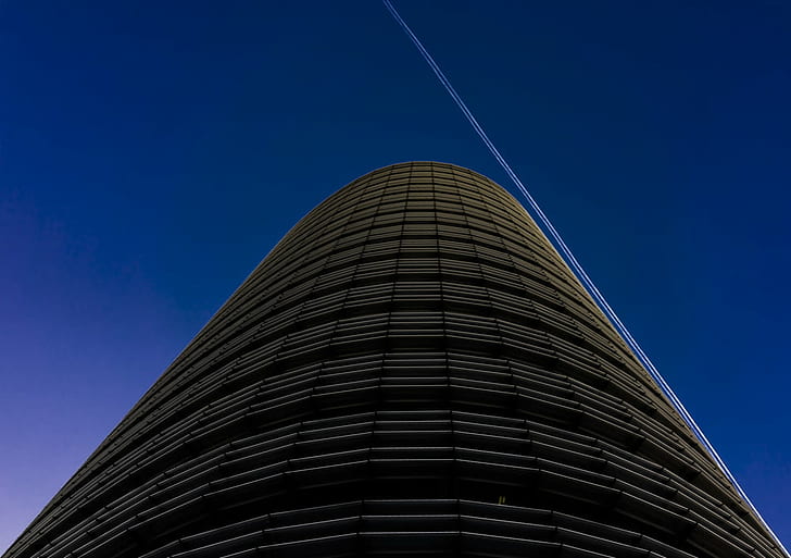 low angle photography of high rise building, deep blue, black cube