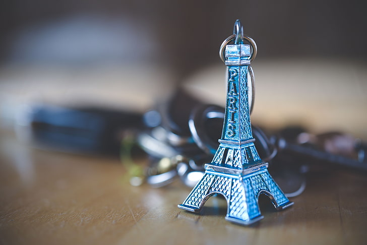 gray metal Eiffel Tower keychain, decoration, close-up, table