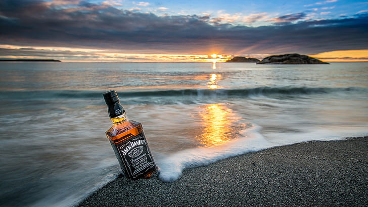 horizon  waves  rock  nature  landscape  sunrise  sand  bottles  reflection  sea  clouds  island  coast  beach  whiskey  Jack Daniels, HD wallpaper