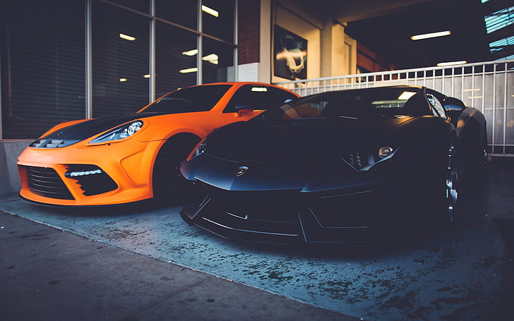 two black and orange coupes, two orange and black Lamborghini cars