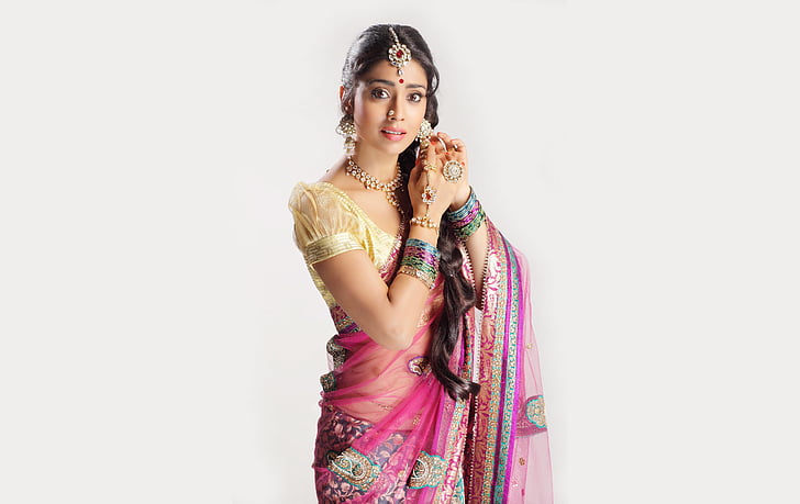 woman wearing beige and pink ghagra cholli traditional dress