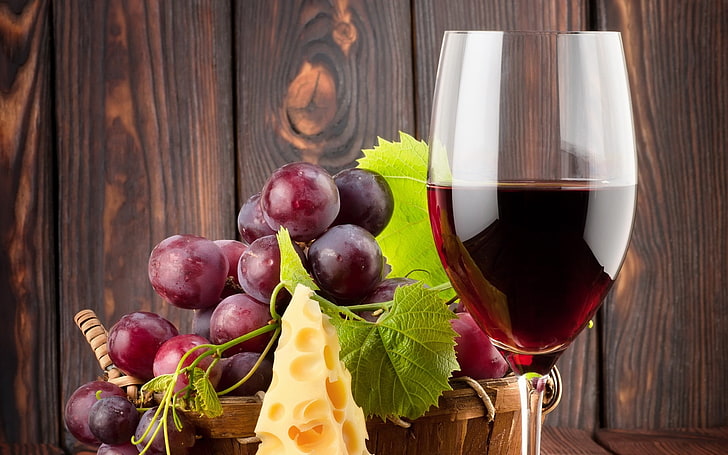 wine glass beside grapes, cheese, alcohol, food, food and drink