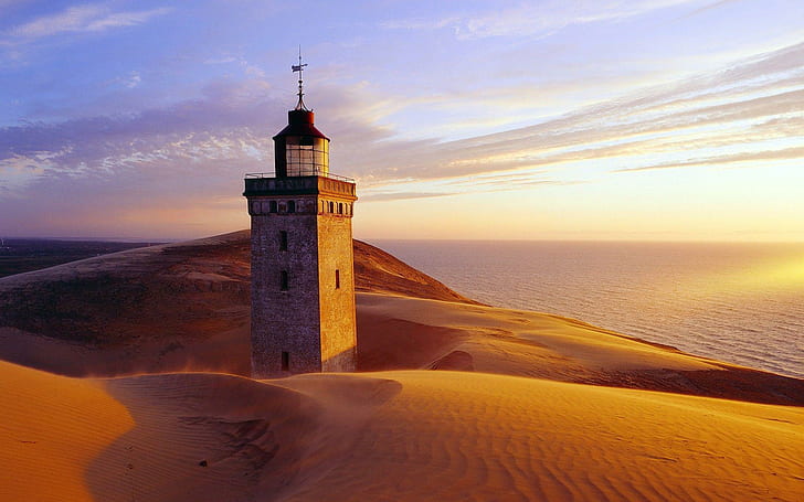 Rubjerg Knude lighthouse, white and black concrete tower surrounded by sand